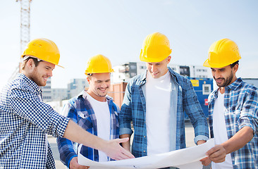 Image showing group of builders with tablet pc and blueprint