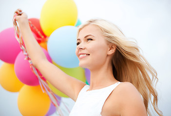 Image showing woman with colorful balloons outside