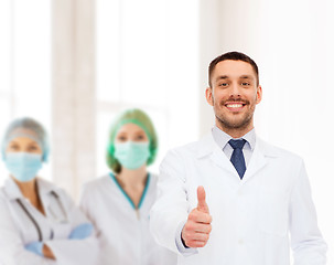 Image showing smiling male doctor showing thumbs up