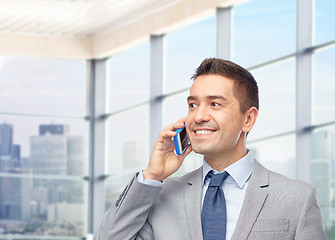 Image showing happy businessman calling on smartphone