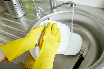 Image showing close up of woman hands washing dishes in kitchen