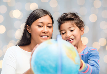 Image showing mother and daughter with globe