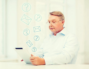 Image showing old man with tablet computer at home