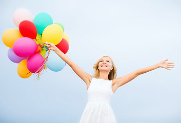 Image showing woman with colorful balloons outside