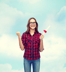 Image showing smiling female student in eyeglasses with diploma