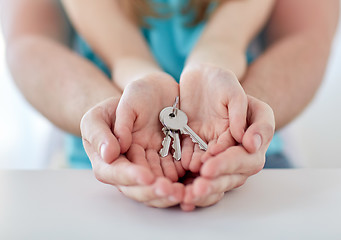 Image showing close up of man and girl hands with house keys