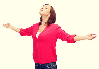 Image showing smiling woman waving hands with closed eyes