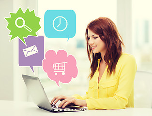 Image showing smiling woman with laptop computer at home