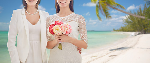 Image showing close up of happy lesbian couple with flowers