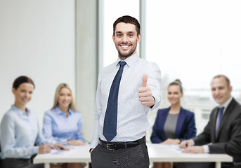 Image showing handsome businessman showing thumbs up