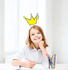 Image showing smiling little school girl drawing at home