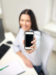 Image showing close up of woman showing smartphone at office