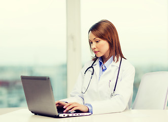 Image showing busy doctor with laptop computer