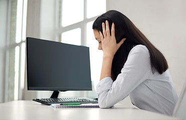 Image showing close up of sad woman with computer and notebook