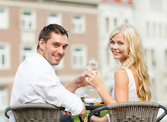 Image showing smiling couple drinking wine in cafe