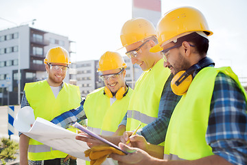 Image showing group of builders with tablet pc and blueprint