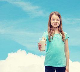 Image showing smiling little girl giving glass of milk