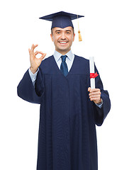 Image showing smiling adult student in mortarboard with diploma