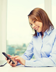 Image showing smiling businesswoman or student with laptop