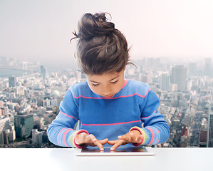 Image showing little girl with tablet pc over city background