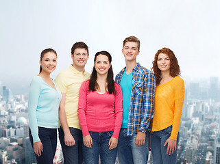 Image showing group of smiling teenagers over city background