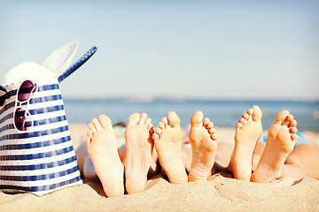 Image showing three women lying on the beach