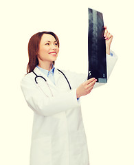 Image showing smiling female doctor looking at x-ray