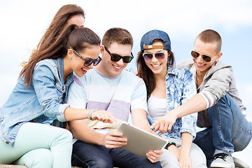 Image showing group of teenagers looking at tablet pc