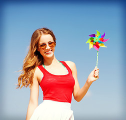 Image showing girl with windmill toy on the beach