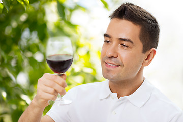 Image showing happy man drinking red wine from glass