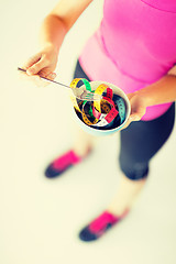 Image showing woman hands holding bowl with measuring tape