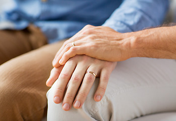 Image showing close up of happy male gay couple holding hands