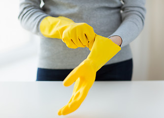 Image showing close up of woman wearing protective rubber gloves