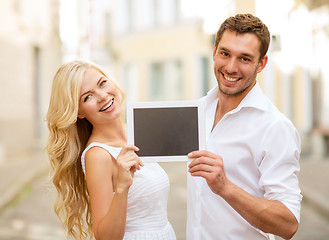 Image showing couple with tablet pc in the city