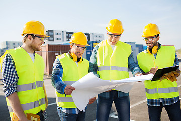 Image showing group of builders with tablet pc and blueprint