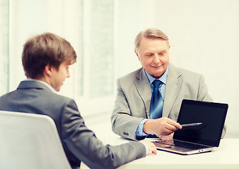 Image showing older man and young man with laptop computer