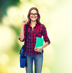 Image showing smiling female student with bag and notebooks