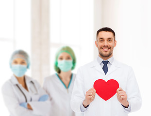 Image showing smiling male doctor with red heart