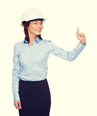 Image showing young smiling businesswoman in white helmet