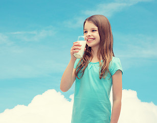 Image showing smiling little girl drinking milk out of glass