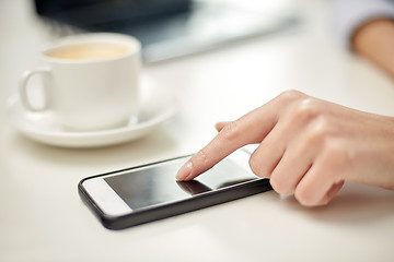 Image showing close up of woman hand with smartphone and coffee