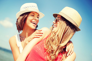 Image showing girls in hats on the beach