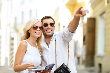 Image showing couple with map, camera and travellers guide