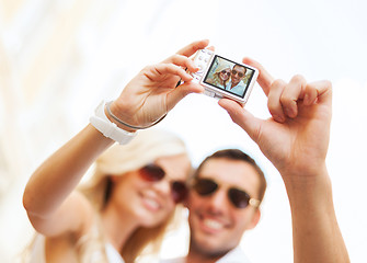 Image showing travelling couple taking photo picture with camera