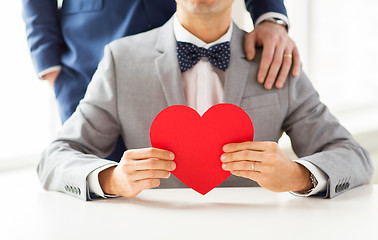 Image showing close up of male gay couple with red heart