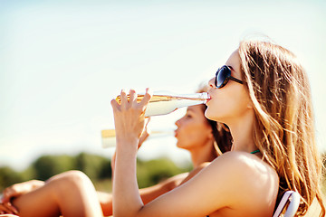 Image showing girls with drinks on the beach chairs