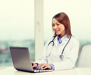 Image showing busy doctor with laptop computer