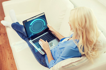 Image showing smiling woman with laptop computer at home