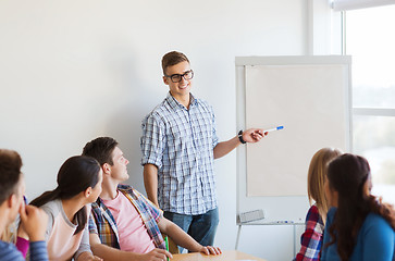 Image showing group of smiling students with white board