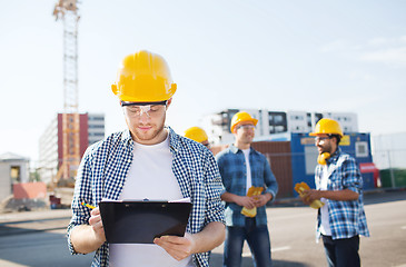 Image showing group of builders in hardhats outdoors